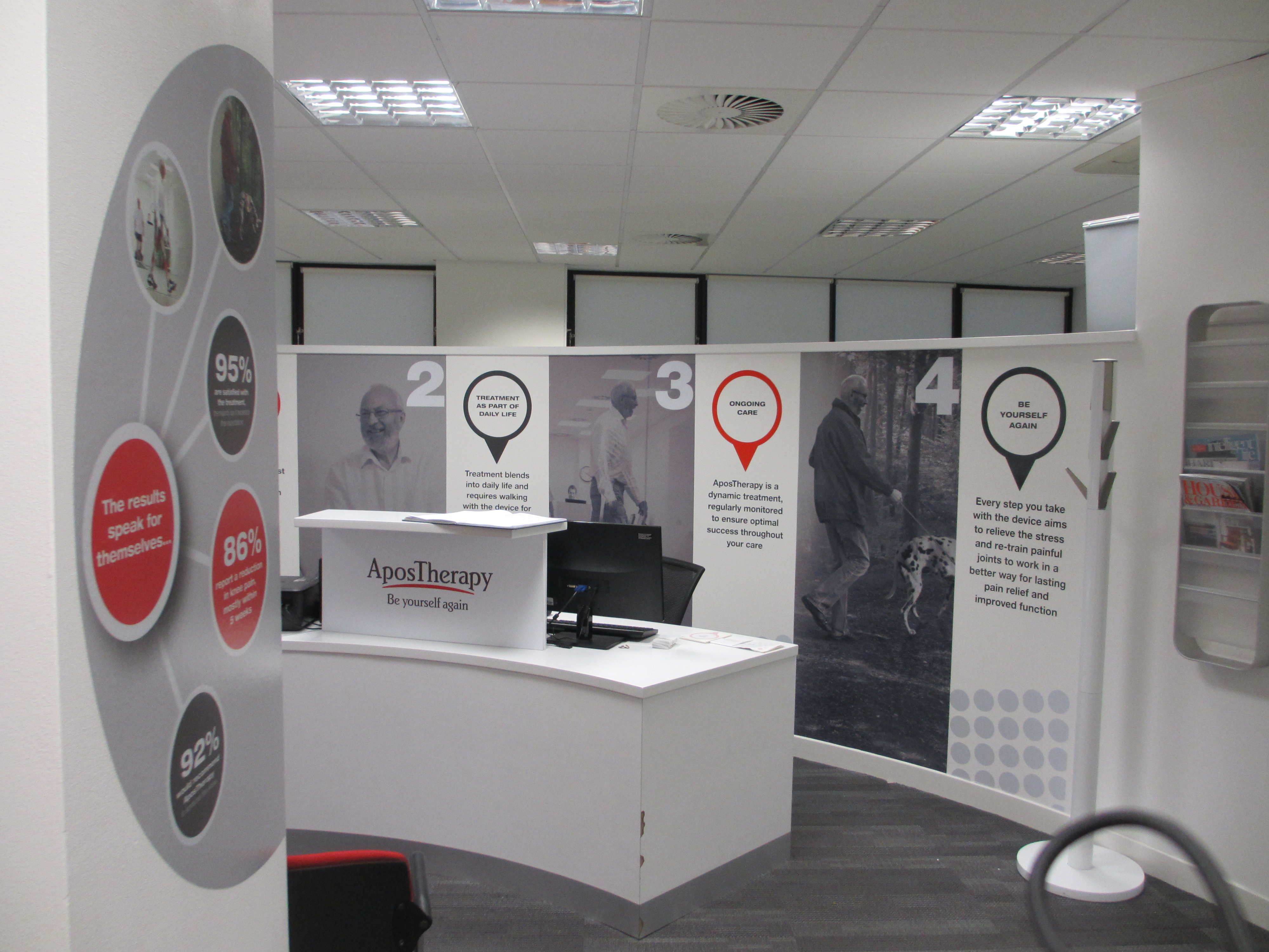 modern clinic reception area features a curved desk with "AposTherapy" branding.